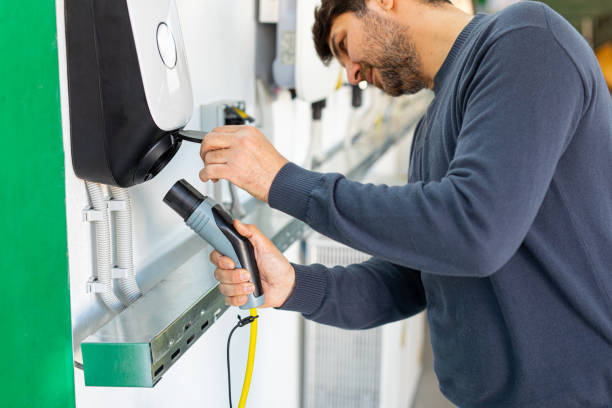 man charging his electric car